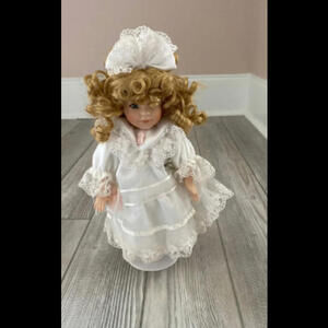 Porcelain Doll with white dress and stand